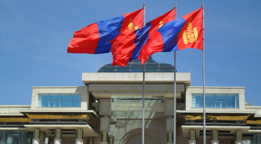 Three Mongolian flags flying in front of the Government Palace on Sukhbaatar Square, Ulaanbaatar.