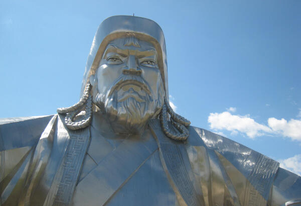 Close-up of the stainless steel Chinggis Khaan Equestrian Statue against a blue sky.